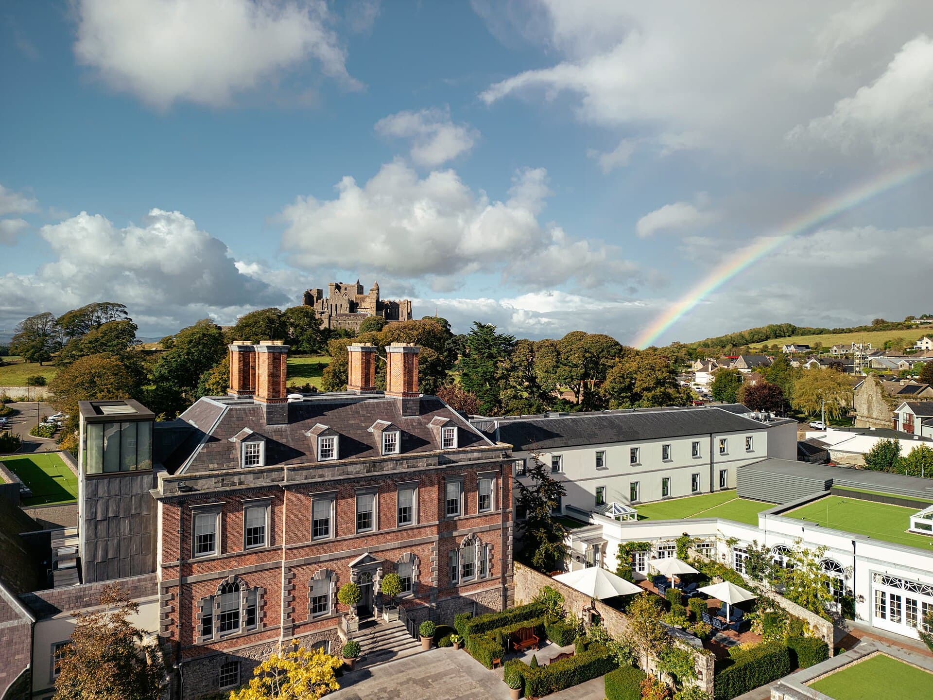 Aerial view of Cashel Palace Hotel with the Rock of Cashel behind