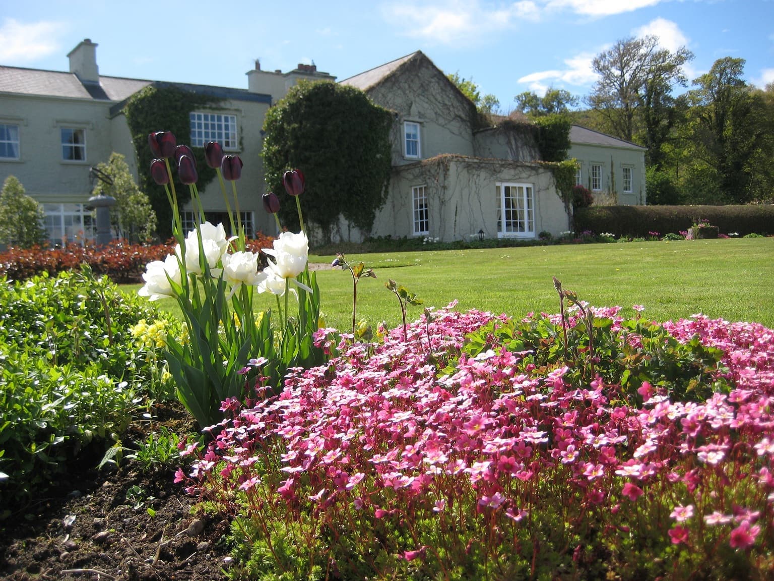 Gregans Castle Hotel seen across its gardens
